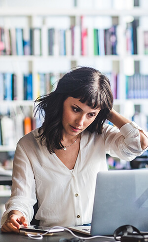 woman working at a standing desk in an office